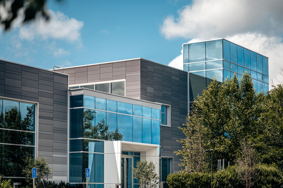 41 Seyon — gradient terracotta panels, fritted glass, adaptive reuse of existing EIFS building